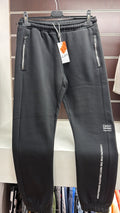 Pantalón jogger juvenil negro con bolsillos de cremallera — fotografía del producto