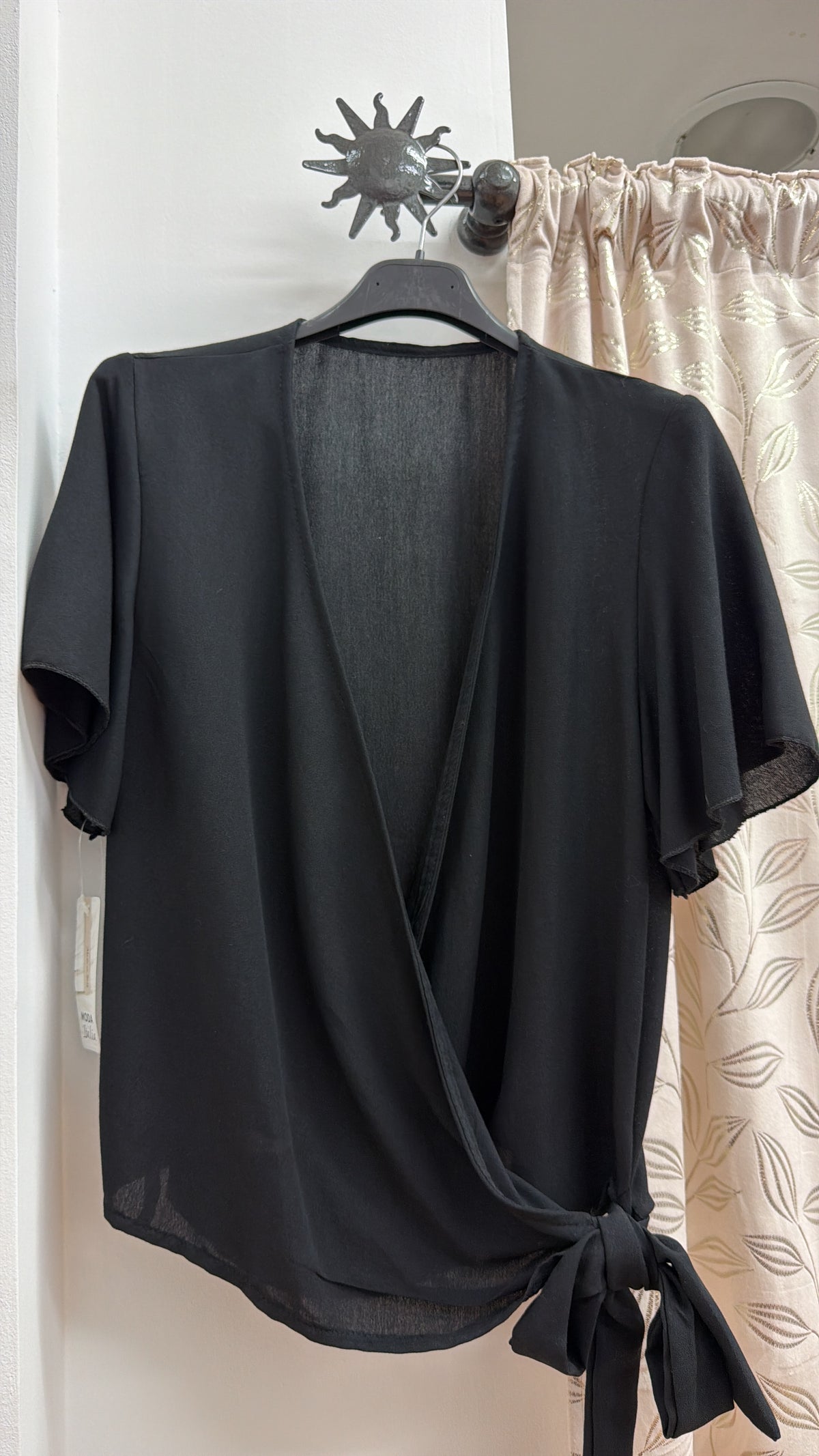Camiseta negra cruzada con lazada lateral — fotografía del producto