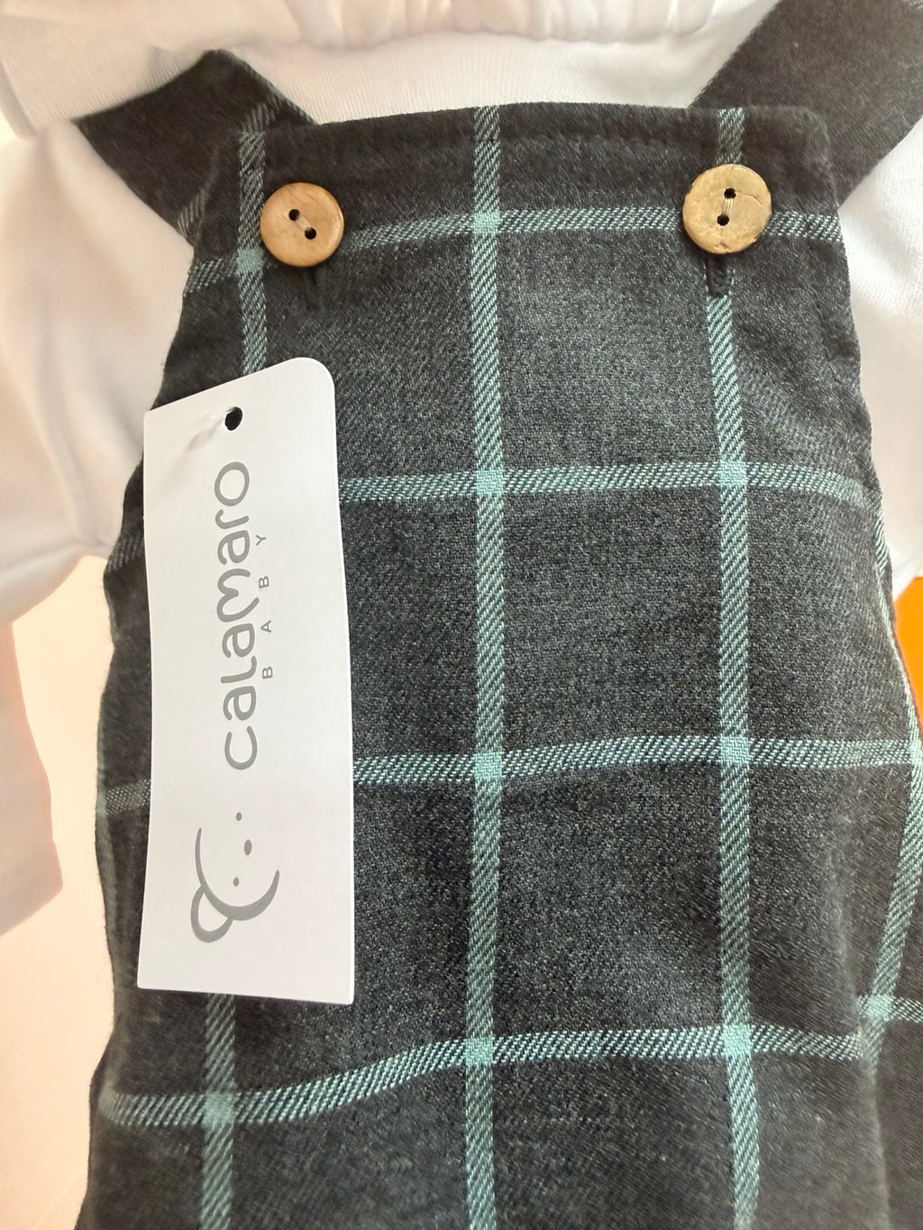 Detalle del tejido de cuadros y botones del peto bebé Calamaro