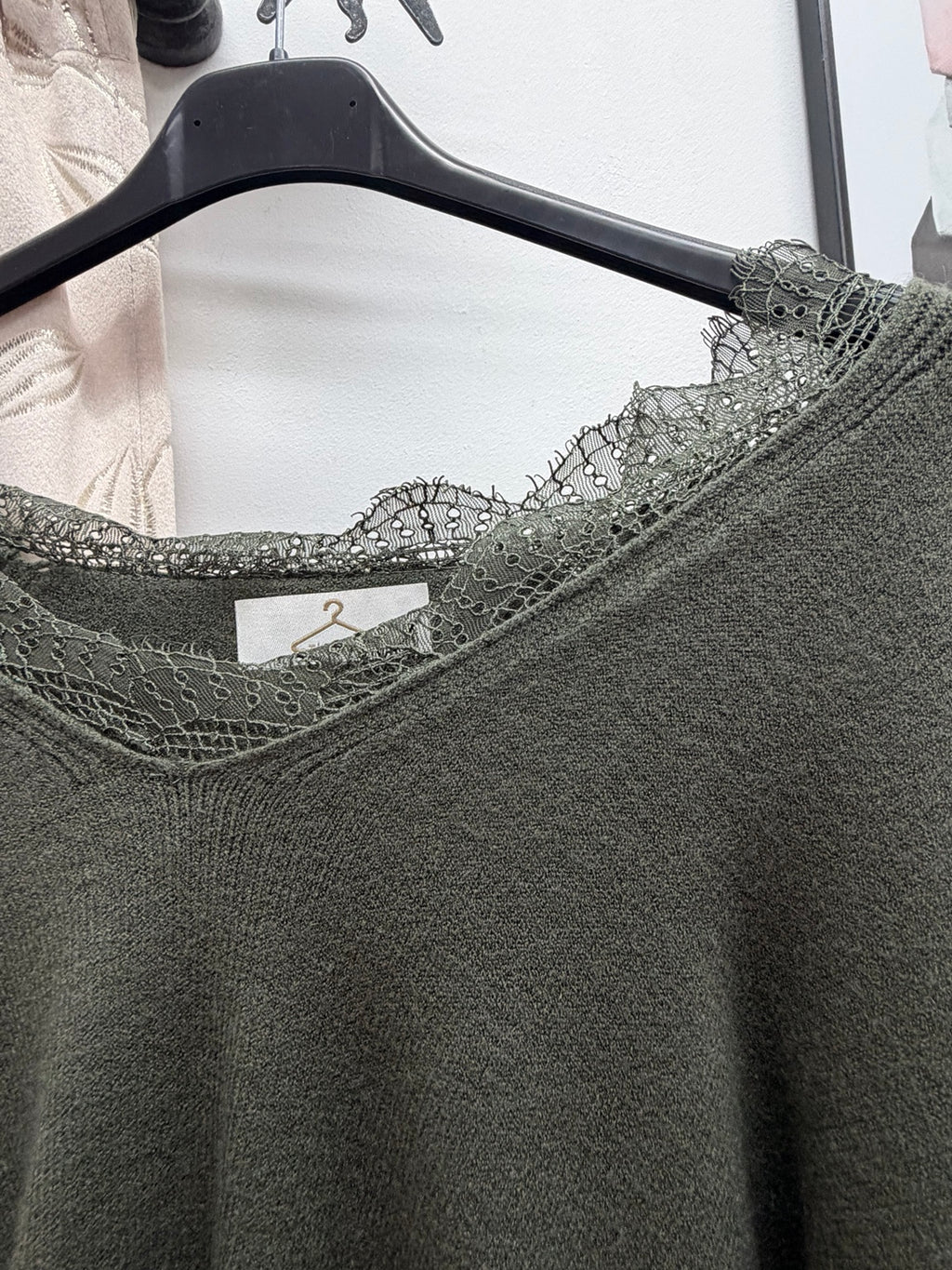 Detalle del encaje en el cuello del jersey de mujer verde caqui