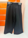 Pantalón niña Losan negro de pata ancha con detalle de estrellas, talla 2 años