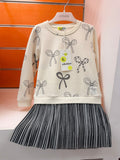 Vestido niña Losan crudo con estampado de lazos y falda plisada gris, talla 4 años